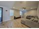 Bright living room with tile floors, neutral walls and a comfortable sectional sofa at 10968 W Baden St, Avondale, AZ 85323