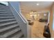 Spacious living area with open floor plan, wood-look flooring, and a view of the kitchen and dining area at 10968 W Baden St, Avondale, AZ 85323