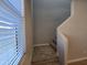 Carpeted staircase leading to the upper level of the home, natural light from the window at 10968 W Baden St, Avondale, AZ 85323