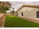 Well-kept backyard with artificial grass, desert landscaping, and block wall provide a low-maintenance outdoor space at 1114 S Presidio Ave, Gilbert, AZ 85233