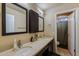 Bathroom featuring double sinks, framed mirrors, neutral walls, and ample vanity space at 1114 S Presidio Ave, Gilbert, AZ 85233