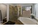 Modern bathroom featuring a glass shower and separate soaking tub by a sunny window at 1114 S Presidio Ave, Gilbert, AZ 85233