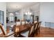 Elegant dining room with wood floors, a chandelier, and views into the living room at 1114 S Presidio Ave, Gilbert, AZ 85233