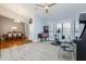 Open-concept living room with ceiling fan, an exercise bike and carpeted flooring at 1114 S Presidio Ave, Gilbert, AZ 85233