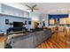 Open-concept living room showcasing hardwood floors, ceiling fan, and seamless flow into the kitchen at 1114 S Presidio Ave, Gilbert, AZ 85233