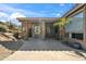 Relaxing back patio area with desert landscaping and a covered porch, perfect for enjoying the outdoors at 11152 E White Feather Ln, Scottsdale, AZ 85262