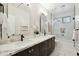 Bright bathroom featuring a dual sink vanity, a shower over tub and modern fixtures, creating a functional space at 11152 E White Feather Ln, Scottsdale, AZ 85262