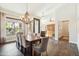 Bright dining room with wood floors, a chandelier, and large windows offering scenic views at 11152 E White Feather Ln, Scottsdale, AZ 85262