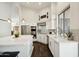 Modern kitchen with stainless steel appliances, white cabinets, and stylish pendant lighting at 11152 E White Feather Ln, Scottsdale, AZ 85262