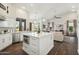 Open-concept kitchen featuring a center island, white cabinets, and stainless-steel appliances at 11152 E White Feather Ln, Scottsdale, AZ 85262