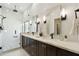 Modern main bathroom showcasing dual vanities, a marble countertop, and a glass-enclosed shower with stylish fixtures at 11152 E White Feather Ln, Scottsdale, AZ 85262