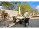 Outdoor patio with a stone fireplace, dining table, and seating area for an inviting entertainment space at 11152 E White Feather Ln, Scottsdale, AZ 85262