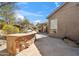 Outdoor kitchen and patio area featuring a built-in grill and desert landscaping for a relaxing entertainment space at 11152 E White Feather Ln, Scottsdale, AZ 85262