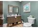 Bathroom featuring a vanity with a marble countertop, a decorative mirror and wood cabinet at 11343 E Appaloosa Pl, Scottsdale, AZ 85259