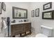 Bathroom featuring a wood vanity with white countertop, toilet, and decorative wall art at 11343 E Appaloosa Pl, Scottsdale, AZ 85259