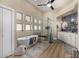 Bright bathroom featuring a soaking tub, glass shower, dual vanities, and wood look flooring at 11343 E Appaloosa Pl, Scottsdale, AZ 85259