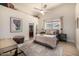 Cozy bedroom with a ceiling fan, patterned rug, and a view of the backyard at 11343 E Appaloosa Pl, Scottsdale, AZ 85259