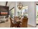 Bright dining area with wicker chairs, round table, and modern light fixture with large glass windows to the patio at 11343 E Appaloosa Pl, Scottsdale, AZ 85259