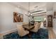 Warm dining room showcasing a wood table, six chairs, modern lighting, and artwork at 11343 E Appaloosa Pl, Scottsdale, AZ 85259