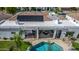 Aerial view showcasing the home's rooftop solar panels with an outdoor living space and tile roof at 11343 E Appaloosa Pl, Scottsdale, AZ 85259