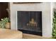 Close up on a modern fireplace with a screen and logs at 11343 E Appaloosa Pl, Scottsdale, AZ 85259