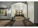 Elegant home entrance with a decorative front door, porch and desert landscaping at 11343 E Appaloosa Pl, Scottsdale, AZ 85259