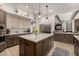 Stylish kitchen featuring a large island, custom cabinetry, and stainless steel appliances at 11343 E Appaloosa Pl, Scottsdale, AZ 85259