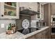 Kitchen detail showcasing a sleek stovetop, granite countertops, and custom tile backsplash at 11343 E Appaloosa Pl, Scottsdale, AZ 85259