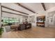 Open living room featuring wood flooring, ceiling beams, modern decor and patio doors at 11343 E Appaloosa Pl, Scottsdale, AZ 85259