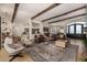 Bright living room with beamed ceilings, comfortable seating, and an open layout to the dining and kitchen areas at 11343 E Appaloosa Pl, Scottsdale, AZ 85259