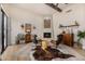 Cozy living room featuring a fireplace, two chairs, and a unique cowhide rug over a neutral area rug at 11343 E Appaloosa Pl, Scottsdale, AZ 85259