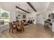 Open-concept living space with beamed ceilings, dining area, fireplace, and seamless flow at 11343 E Appaloosa Pl, Scottsdale, AZ 85259