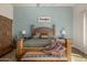 Bright main bedroom showcasing a wooden bed frame, a sitting bench, and an elegant armoire at 11343 E Appaloosa Pl, Scottsdale, AZ 85259