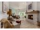 Inviting main bedroom showcasing a stone fireplace, sitting area, plush chairs, and ample natural light from the window at 11343 E Appaloosa Pl, Scottsdale, AZ 85259