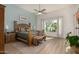 Serene main bedroom with a wooden bed frame, neutral walls, a sitting bench, and a sunlit window with desert view at 11343 E Appaloosa Pl, Scottsdale, AZ 85259