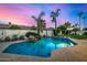 Refreshing backyard pool with a charming rock feature, perfect for relaxing and enjoying the outdoors at 11343 E Appaloosa Pl, Scottsdale, AZ 85259