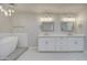 Bright bathroom with a modern standalone tub, dual vanities, and striking hexagonal tile flooring at 114 E Garfield St, Tempe, AZ 85288