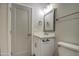 Bathroom vanity with a modern faucet, framed mirror and a gray painted paneled door at 114 E Garfield St, Tempe, AZ 85288