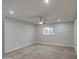 Empty bedroom with neutral carpet, ceiling fan, and natural light at 114 E Garfield St, Tempe, AZ 85288