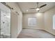 Spacious bedroom with a ceiling fan, window, and a modern barn door leading to the bathroom at 114 E Garfield St, Tempe, AZ 85288