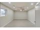 An empty bedroom featuring neutral walls, ceiling fan and wood-look tile flooring at 114 E Garfield St, Tempe, AZ 85288