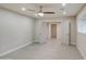 An empty bedroom featuring neutral walls, ceiling fan and wood-look tile flooring at 114 E Garfield St, Tempe, AZ 85288