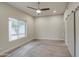 Bright, carpeted bedroom with a large window and a modern ceiling fan at 114 E Garfield St, Tempe, AZ 85288