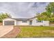 Charming single-story home boasts a manicured lawn, tasteful landscaping, and a modern garage at 114 E Garfield St, Tempe, AZ 85288