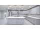 Bright kitchen showcasing white countertops, gray cabinets, stainless steel appliances, and modern pendant lighting at 114 E Garfield St, Tempe, AZ 85288