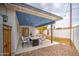 Charming covered patio features a modern concrete dining table, perfect for outdoor entertaining and dining al fresco at 114 E Garfield St, Tempe, AZ 85288