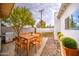 Backyard patio with wood dining set, grill, and neat landscaping offers a great spot for outdoor cooking and relaxing at 114 E Garfield St, Tempe, AZ 85288