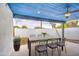 Stylish covered patio with a concrete dining table, ceiling fan, and modern design offers a relaxing outdoor space at 114 E Garfield St, Tempe, AZ 85288