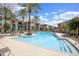 Outdoor pool surrounded by lounge chairs, palm trees, and lush landscaping at 11640 N Tatum Blvd # 2063, Phoenix, AZ 85028