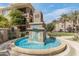 Outdoor fountain with turquoise water and lush landscaping at 11640 N Tatum Blvd # 2063, Phoenix, AZ 85028